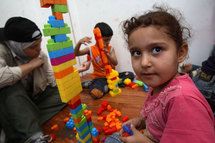 Girl with toys, photo c. UNHCR