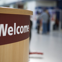 Front of a reception desk with welcome sign c. Jenny Wicks